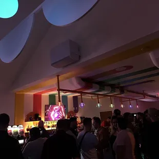 a crowd of people in a brightly lit room