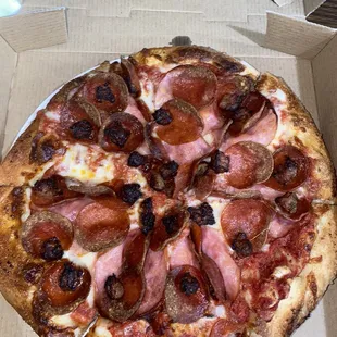 Pepperoni, sausage, and Canadian bacon pizza