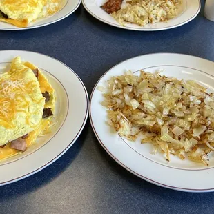 Meat trio omelette, coffee and hash browns covered in onions!