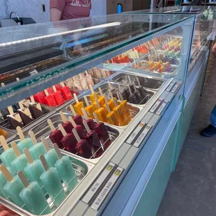 a woman standing in front of a display of pops