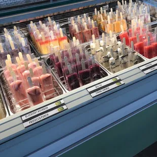 a variety of pops in a display case