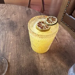a glass of lemonade with a slice of lemon