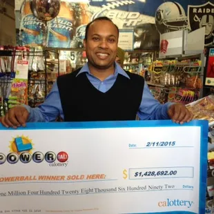 a man holding a large check
