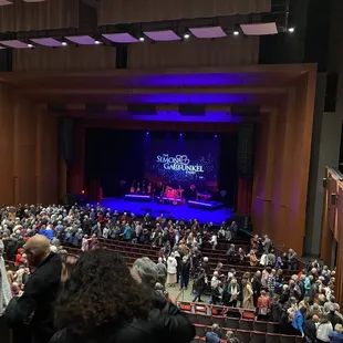 a large crowd of people in a large auditorium