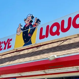 a sign on the roof of a liquor shop