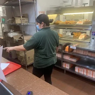 a woman working in a restaurant kitchen