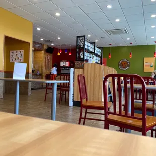 the inside of a restaurant with tables and chairs