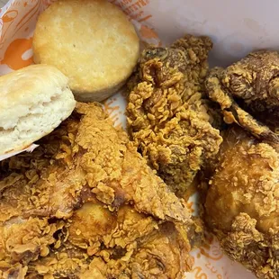 a basket of fried chicken and biscuits