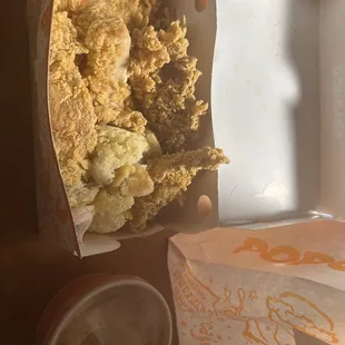 The picture shows chicken tenders with a broken biscuit mixed in, looking messy and possibly tampered with. It&apos;s very unsatisfying.