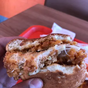 a hand holding a sandwich