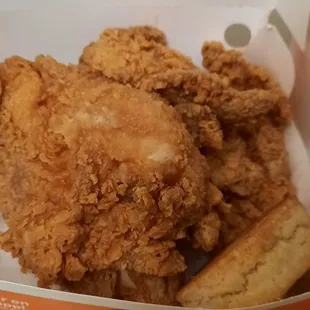a basket of fried chicken and dips