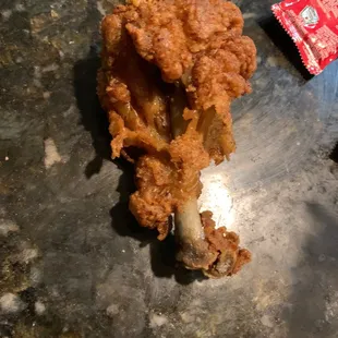 This is NOT a chicken leg. This is a burnt piense of something that looks like a dog might have taken a bite out of it.