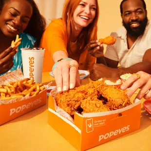 a group of people eating popeyes