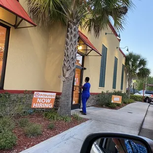 a woman standing outside of a restaurant