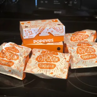 Spicy and Mild Chicken Sandwiches with a box of Cajun Fries and A box of biscuits.