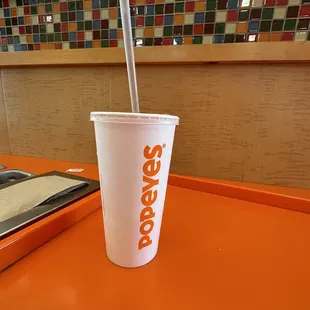 a paper cup with a straw