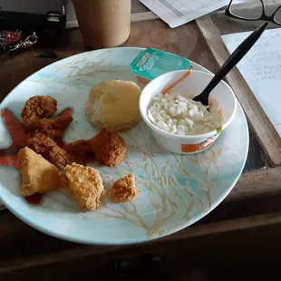 Popeye's Surf and Turf meal. 7.00. No drink included. Three shrimp, three small pieces of chicken, biscuit and slaw.