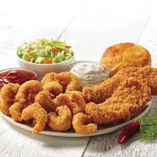 a plate of fried chicken nuggies and a side of coleslaw