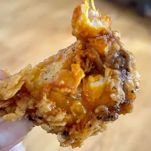 Wings only come spicy (it's in the chicken) and they just pour the sauce on it. They don't offer dry rubs like Wingstop. 6 for $6.