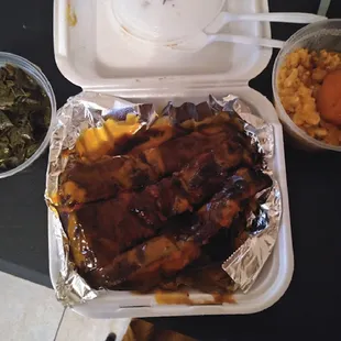 a tray of ribs and vegetables