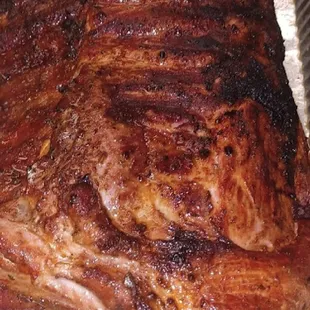 a large roast of meat in a pan