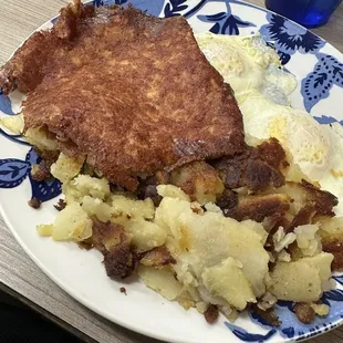 Corned beef hash, with 2 eggs over easy, home fries, and a grilled biscuit.  Delicious!