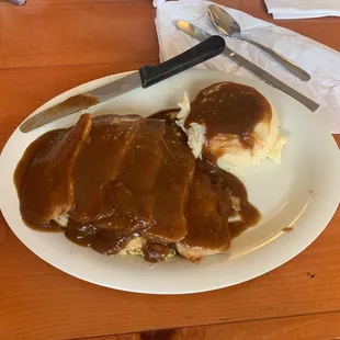 a plate of food with gravy and mashed potatoes