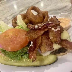 Burger with onion rings and bacon. Pretty good with lots of bacon.