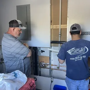 two men working on a kitchen