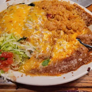 Spinach enchilada plate with refried beans and Spanish rice