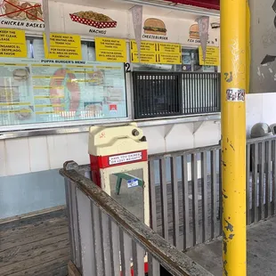 a yellow post in front of a restaurant
