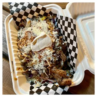 Potato Tacos: 2 crispy potato filled tacos / topped with shredded pork / refried beans / cabbage / cotija cheese / salsa rojo / crema