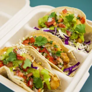 three tacos in a styrofoam container