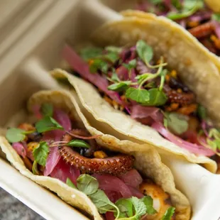 two tacos in a styrofoam container