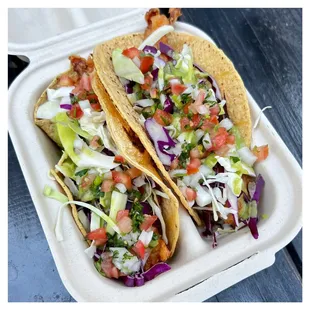 Mahi Mahi Tacos: 2 fish tacos beer battered / topped with cabbage / avocado sauce / pico de gallo / corn tortillas