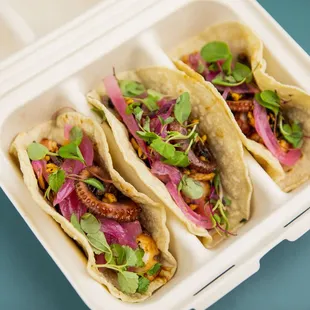 three tacos in a styrofoam container