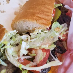 a sandwich with lettuce, tomato, and cheese