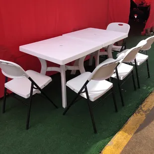 a white table and white chairs