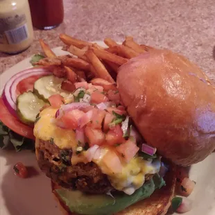 Giant veggie burger. Hand cut fries hiding behind