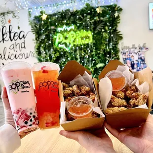 a person holding a tray of food