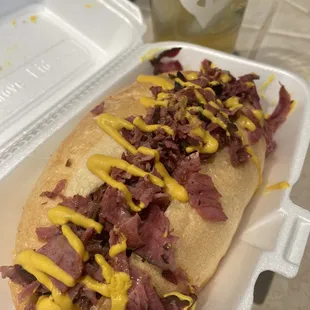 a hot dog with mustard