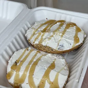two bagels covered in cream and drizzle