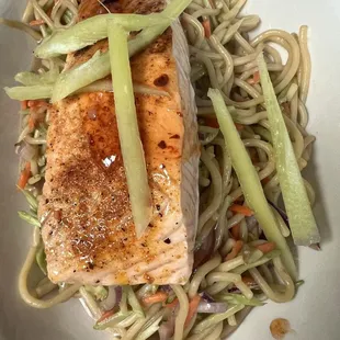 a plate of salmon and noodles