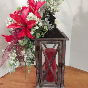 Natural wood lantern with metal top. Dressed in your choice of color theme. Stands 18" high and 7" wide. Candle included