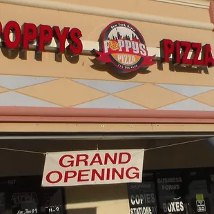 The grand opening sign that led us into Poppy&apos;s Pizza.