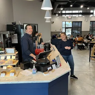 a man and a woman standing in front of a counter