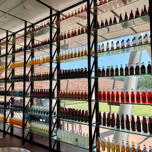 The walls decorated with soda bottles.