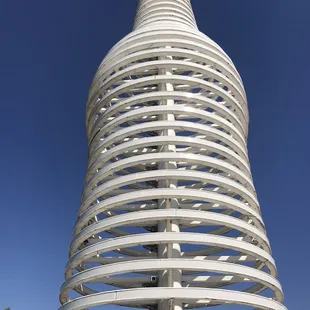 a white spiral structure with a blue sky in the background