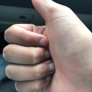 the thumb of a person giving a thumbs up