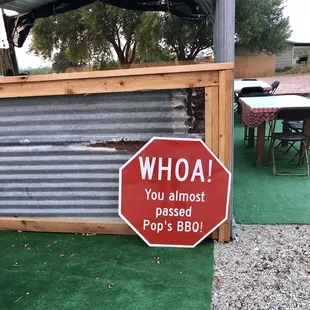 a sign that says whoa you almost passed pop's bbq